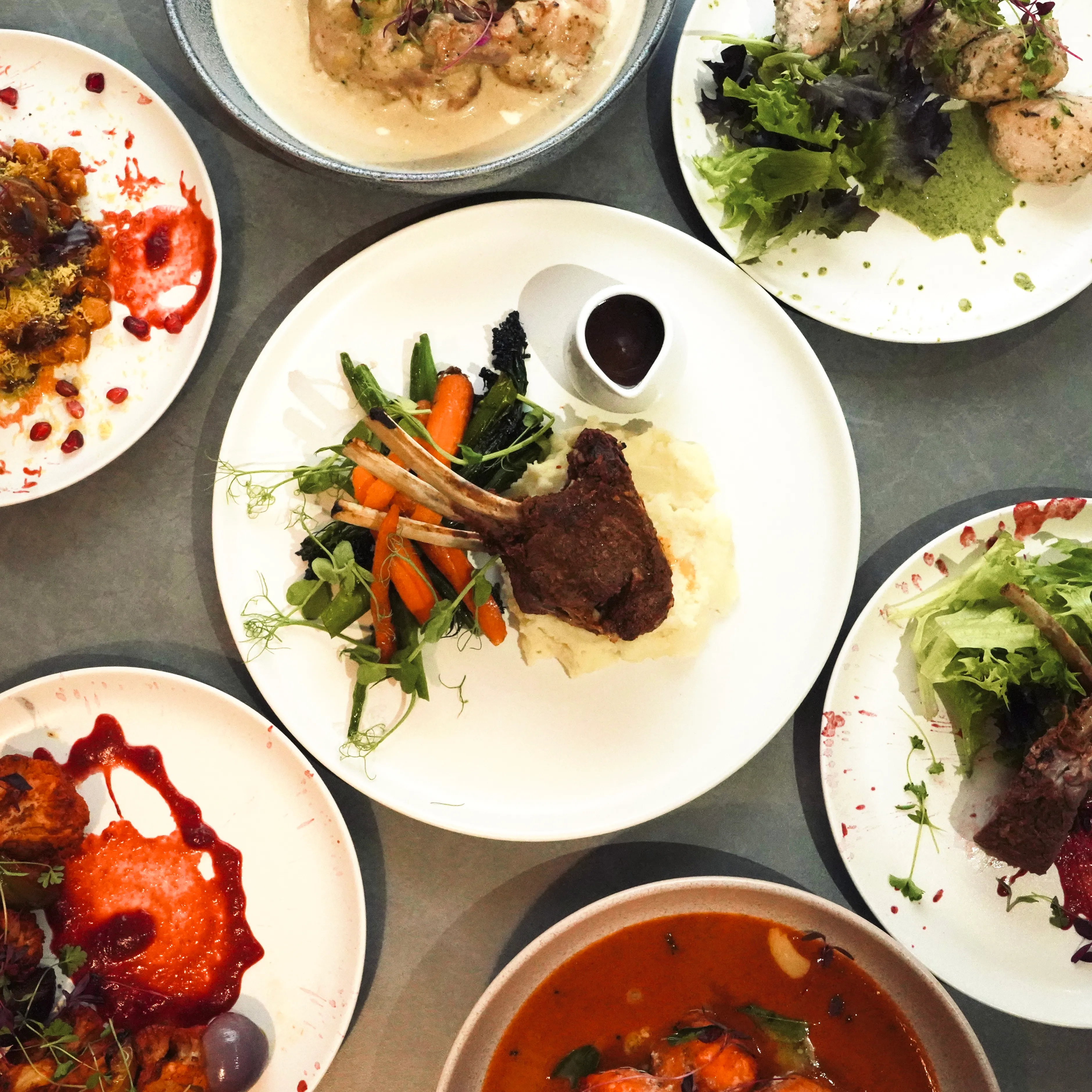 Overhead flat-lay of a multi-course tasting menu.